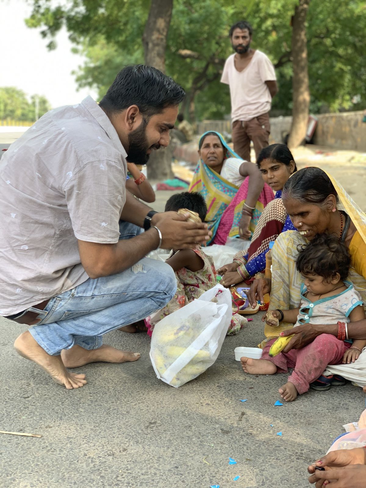Charity volunteers distributing wholesome meal packages to rural families with warm smiles